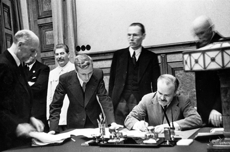 Signing of the Molotov-Ribbentrop Pact; treaty between Germany and the Union of Soviet Socialist Republics (USSR), signed in Moscow on August 23, 1939Чa few days before the beginning of World War IIЧby Nazi foreign minister Joachim von Ribbentrop and Soviet commissar for foreign affairs Vyacheslav Molotov (in the pic., sitting), and in the presence of Soviet dictator Joseph Stalin. Standing (l-r) - Joachim von Ribbentrop, Iosif Stalin, V. Pavlo and F. Gauss.